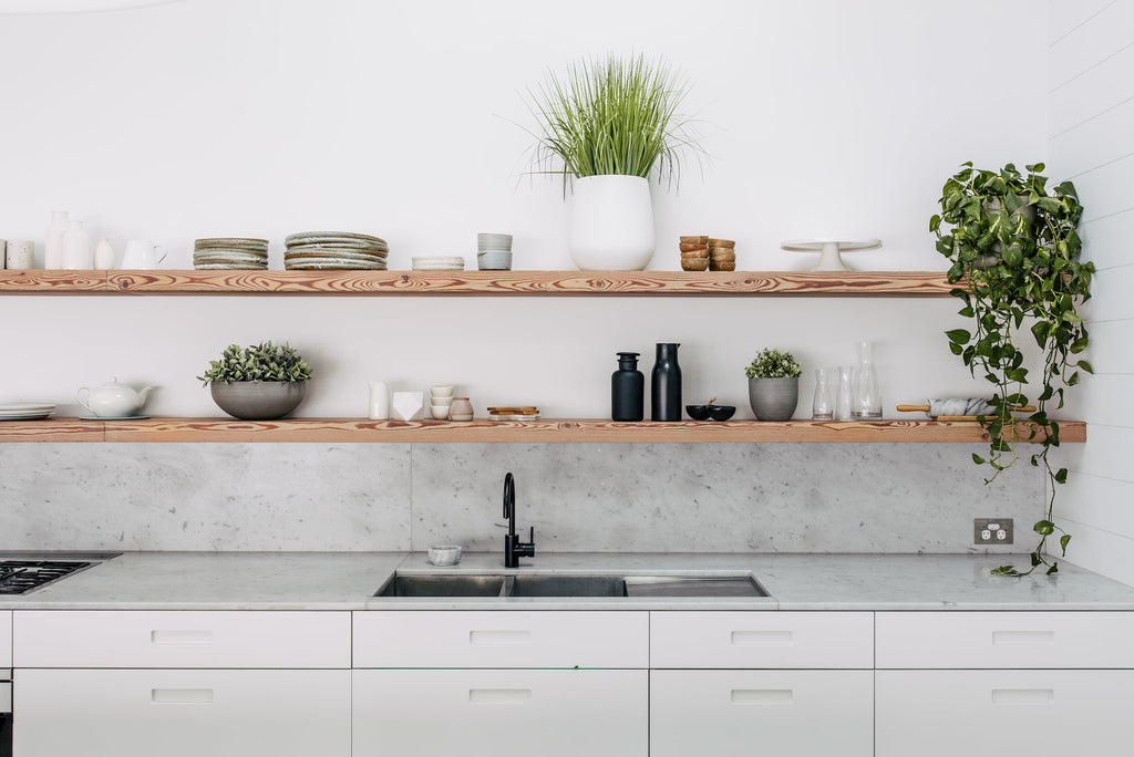 Modern kitchen decor with Slugg plant pots on wooden shelves, featuring lush greenery that complements the clean marble countertops